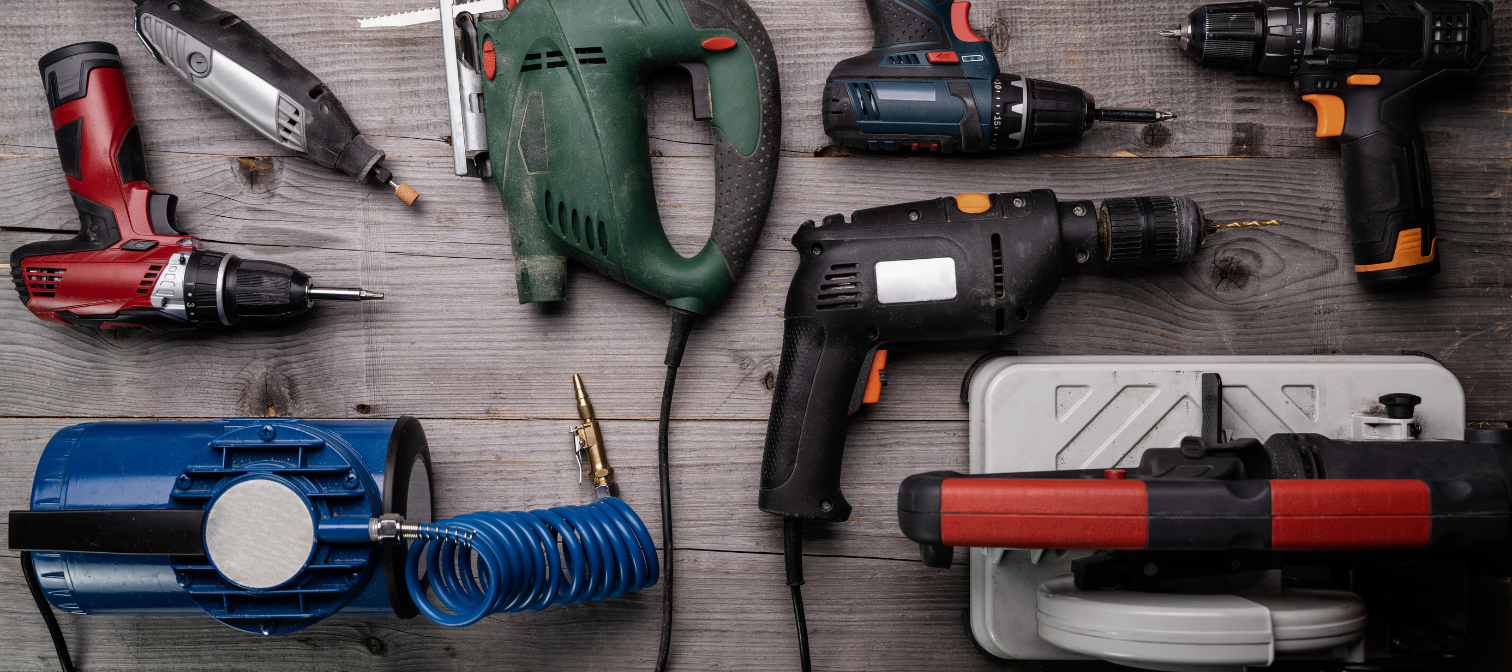 An array of hand and power tools including a compressor, a circular saw, drills, a jigsaw, and a dremel tool.